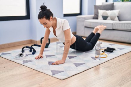 Photo for Young caucasian woman training push up at home - Royalty Free Image