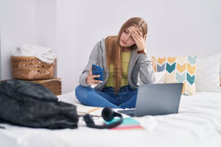 Photo for Young caucasian woman using smartphone with serious expression at bedroom - Royalty Free Image