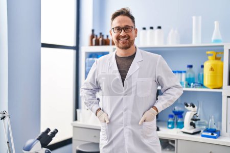 Photo for Young caucasian man scientist smiling confident standing at laboratory - Royalty Free Image