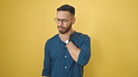Photo for Young hispanic man with sore throat over isolated yellow background - Royalty Free Image