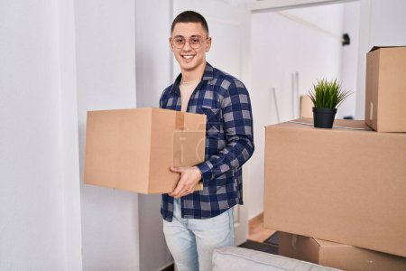 Photo for Young hispanic man smiling confident holding package at new home - Royalty Free Image