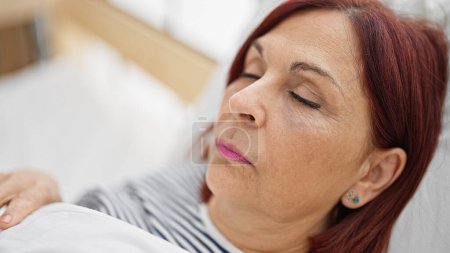 Photo for Middle age woman lying on bed sleeping at bedroom - Royalty Free Image