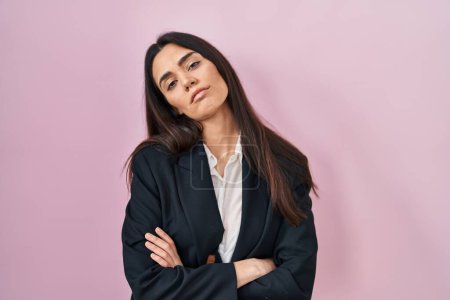 Photo for Young brunette woman wearing business style over pink background looking sleepy and tired, exhausted for fatigue and hangover, lazy eyes in the morning. - Royalty Free Image