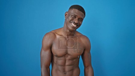 Photo for African american man smiling confident standing shirtless over isolated blue background - Royalty Free Image