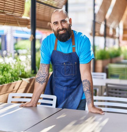 Photo for Young bald man waiter smiling confident standing at coffee shop terrace - Royalty Free Image
