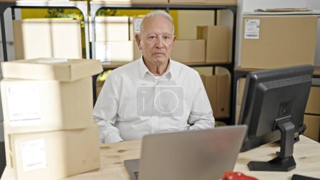 Photo for Senior grey-haired man ecommerce business worker using laptop working at office - Royalty Free Image
