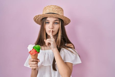 Photo for Teenager girl holding ice cream asking to be quiet with finger on lips. silence and secret concept. - Royalty Free Image