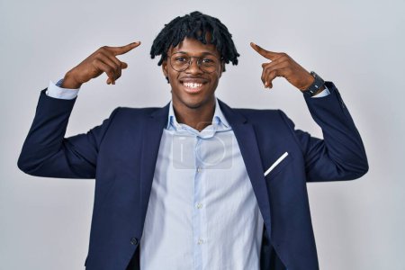 Photo for Young african man with dreadlocks wearing business jacket over white background smiling pointing to head with both hands finger, great idea or thought, good memory - Royalty Free Image