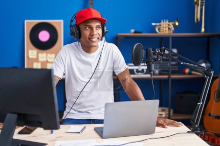 Photo for Young latin man musician having dj session at music studio - Royalty Free Image