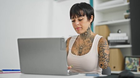 Photo for Hispanic woman with amputee arm business worker using laptop working at the office - Royalty Free Image