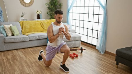 Photo for Young arab man training legs exercise at home - Royalty Free Image