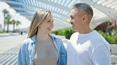 Téléchargez les photos : Homme et femme couple regardant l'autre debout ensemble au parc - en image libre de droit