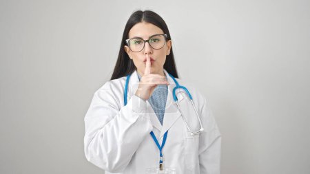 Photo for Young hispanic woman doctor asking for silent over isolated white background - Royalty Free Image