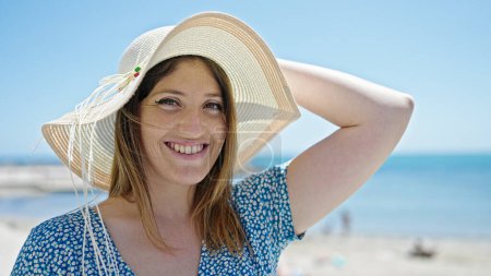 Photo for Young blonde woman tourist smiling confident standing at seaside - Royalty Free Image