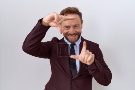 Photo for Middle age business man with beard wearing suit and tie smiling making frame with hands and fingers with happy face. creativity and photography concept. - Royalty Free Image