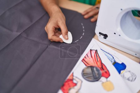 Photo for Middle age grey-haired woman tailor make mark on cloth at tailor shop - Royalty Free Image