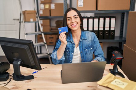 Photo for Young beautiful hispanic woman ecommerce business worker using laptop and credit card at office - Royalty Free Image