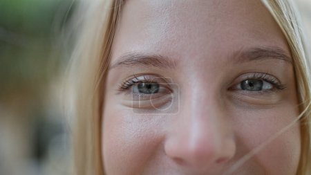 Photo for Young blonde woman close up of eyes smiling at street - Royalty Free Image