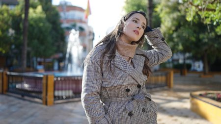 Photo for Beautiful hispanic woman standing with worried expression at park - Royalty Free Image