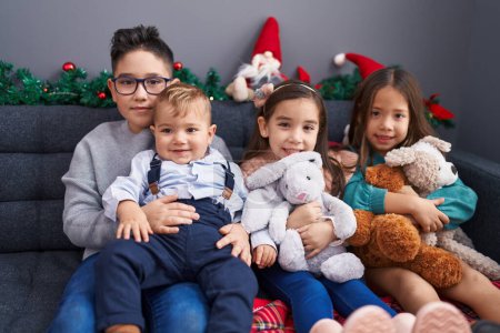 Photo for Group of kids smiling confident sitting on sofa by christmas decoration at home - Royalty Free Image