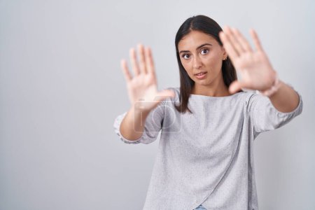 Photo for Young hispanic woman standing over white background doing frame using hands palms and fingers, camera perspective - Royalty Free Image