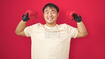 Photo for Smiling confident doing strong gesture over isolated red background - Royalty Free Image