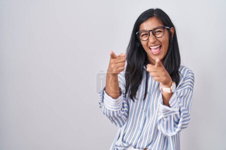 Photo for Young hispanic woman wearing glasses pointing fingers to camera with happy and funny face. good energy and vibes. - Royalty Free Image