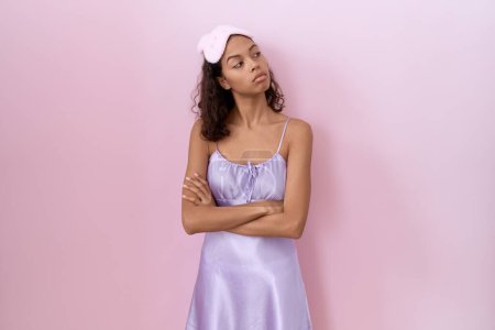 Photo for Young hispanic woman wearing sleep mask and nightgown looking to the side with arms crossed convinced and confident - Royalty Free Image