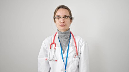 Photo for Young caucasian woman doctor standing with serious expression over isolated white background - Royalty Free Image