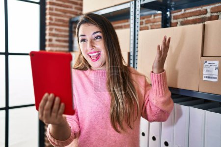 Photo for Young beautiful hispanic woman ecommerce business worker having video call at office - Royalty Free Image