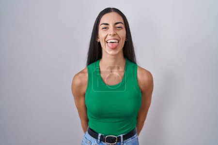 Photo for Young woman standing over isolated background sticking tongue out happy with funny expression. emotion concept. - Royalty Free Image