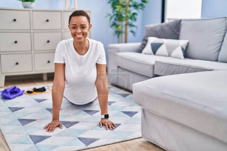 Photo for African american woman smiling confident stretching back at home - Royalty Free Image