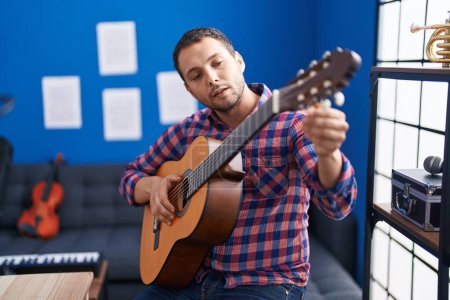 Photo for Young man musician playing classical guitar at music studio - Royalty Free Image