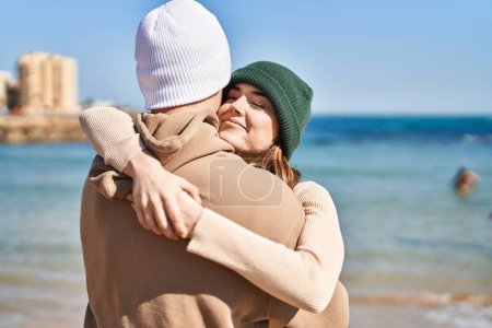 Foto de Mand y mujer pareja abrazándose y besándose en la playa - Imagen libre de derechos