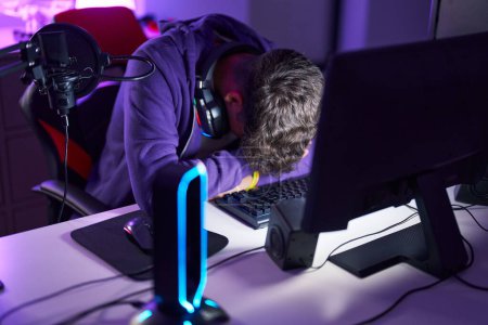 Photo for Young hispanic teenager streamer stressed using computer at gaming room - Royalty Free Image