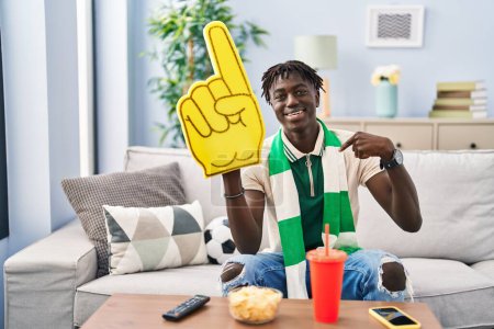 Photo for African man with dreadlocks football hooligan supporting team pointing finger to one self smiling happy and proud - Royalty Free Image