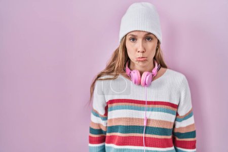 Photo for Young blonde woman standing over pink background depressed and worry for distress, crying angry and afraid. sad expression. - Royalty Free Image