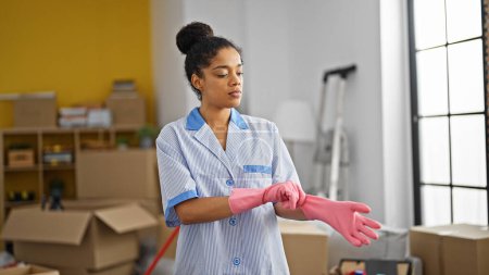 Photo for African american woman clean professional wearing gloves at new home - Royalty Free Image