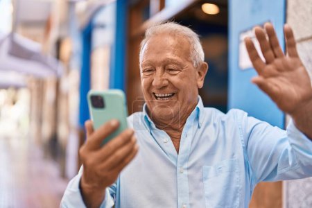 Photo for Senior grey-haired man smiling confident make selfie by smartphone at street - Royalty Free Image
