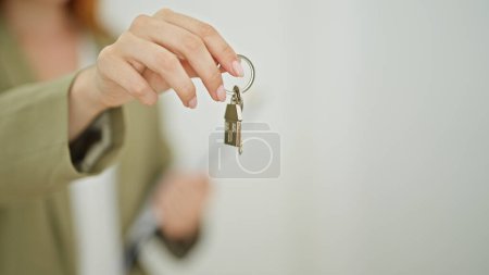 Photo for Young redhead woman real state agent holding keys at home - Royalty Free Image