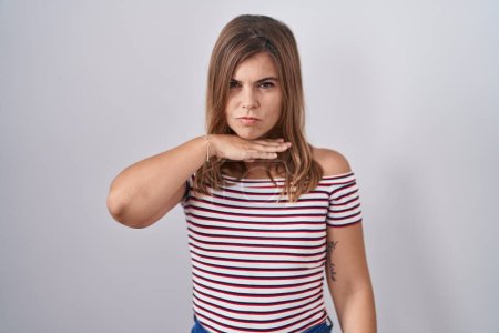 Photo for Young hispanic woman standing over isolated background cutting throat with hand as knife, threaten aggression with furious violence - Royalty Free Image