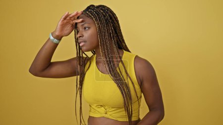Photo for African american woman looking to the side far away over isolated yellow background - Royalty Free Image