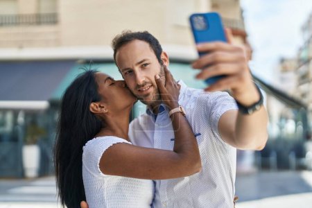 Photo for Man and woman interracial couple making selfie by smartphone at street - Royalty Free Image