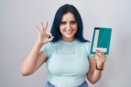 Photo for Young modern girl with blue hair holding l sign for new driver doing ok sign with fingers, smiling friendly gesturing excellent symbol - Royalty Free Image
