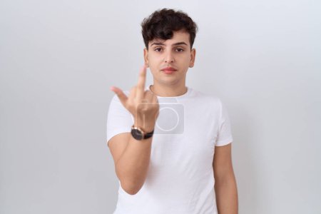 Téléchargez les photos : Young non binary man wearing casual white t shirt showing middle finger, impolite and rude fuck off expression - en image libre de droit