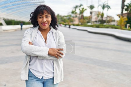 Photo for Young beautiful latin woman standing with arms crossed gesture at park - Royalty Free Image