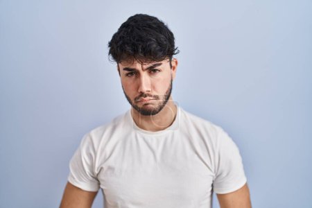 Photo for Hispanic man with beard standing over white background depressed and worry for distress, crying angry and afraid. sad expression. - Royalty Free Image