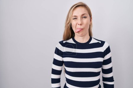 Photo for Young caucasian woman wearing casual navy sweater sticking tongue out happy with funny expression. emotion concept. - Royalty Free Image