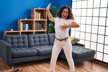 Photo for Middle age hispanic woman dancing at home - Royalty Free Image