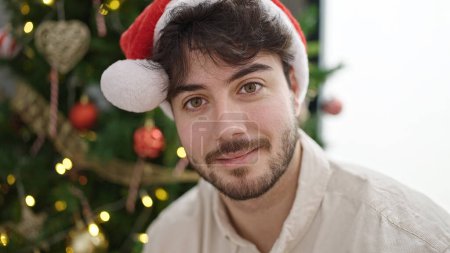 Photo for Young hispanic man smiling confident celebrating christmas at home - Royalty Free Image